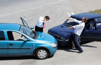 two nervous drivers ouside their cars after a collision