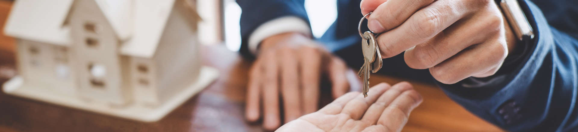 a person receiving home keys to a new house