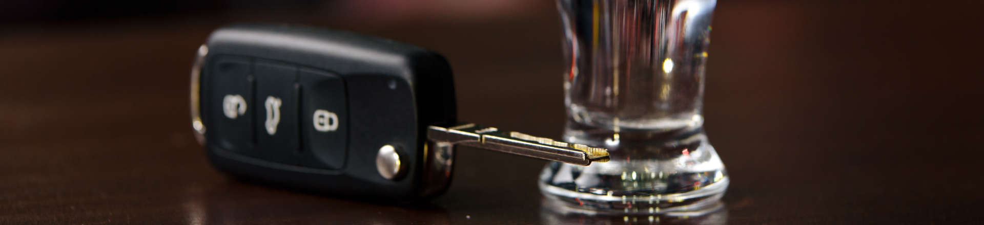 car keys next to a glass with drink