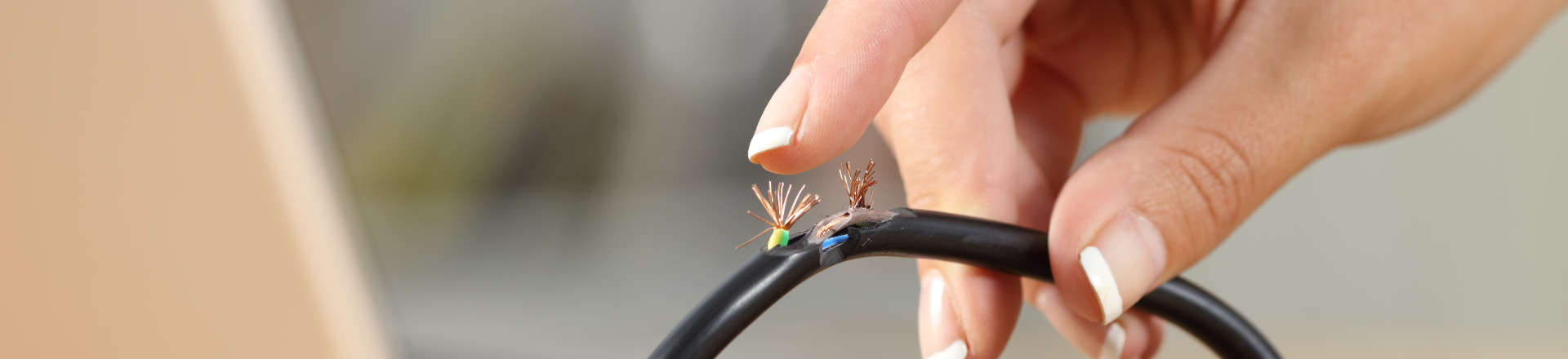 a person holding a damaged cable
