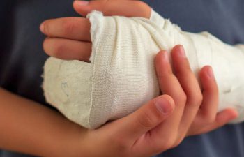 a child with injured hand covered with a bandage
