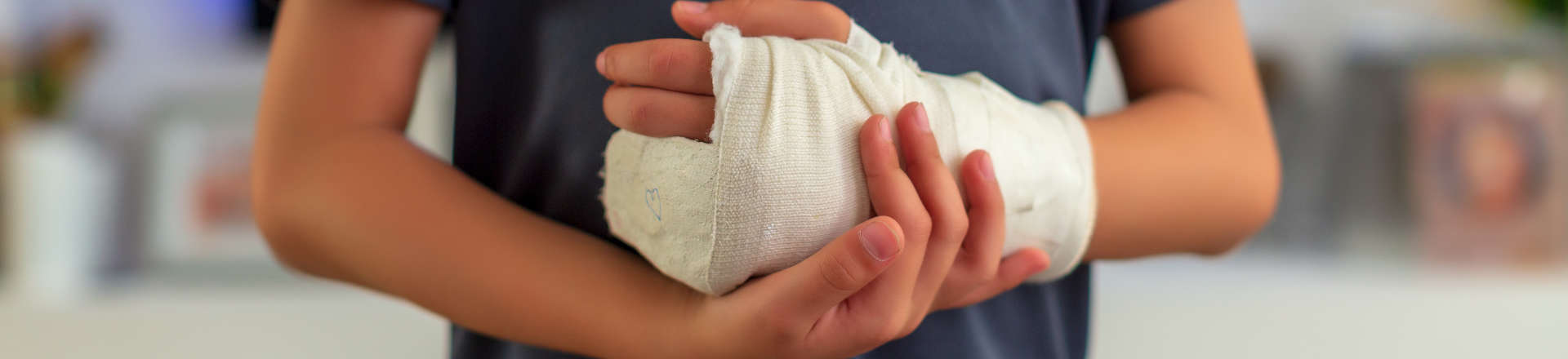 a child with injured hand covered with a bandage