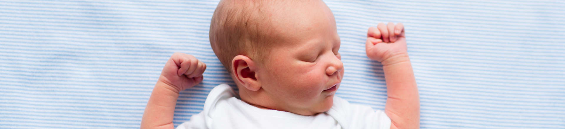 a a newborn baby sleeping on its back