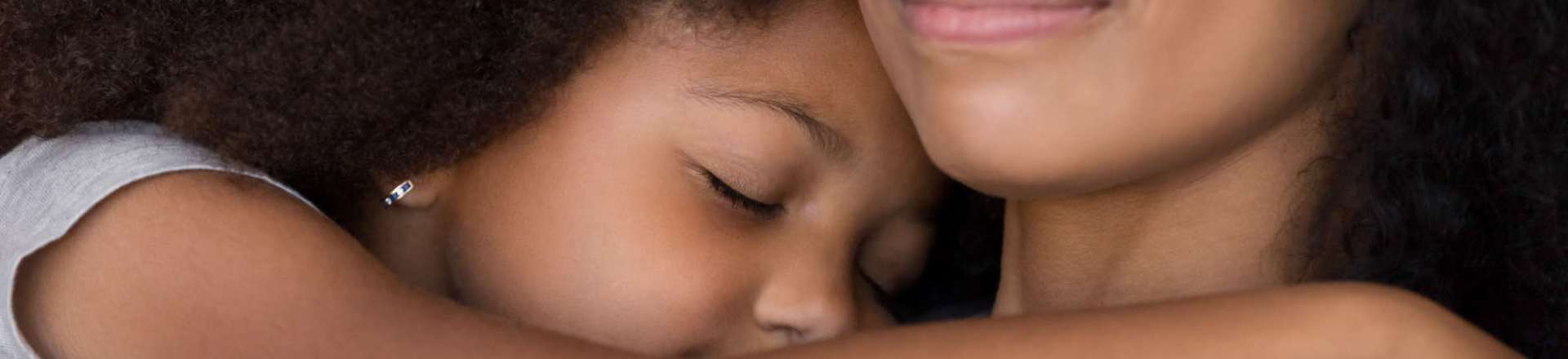 a little girl hugging her mother