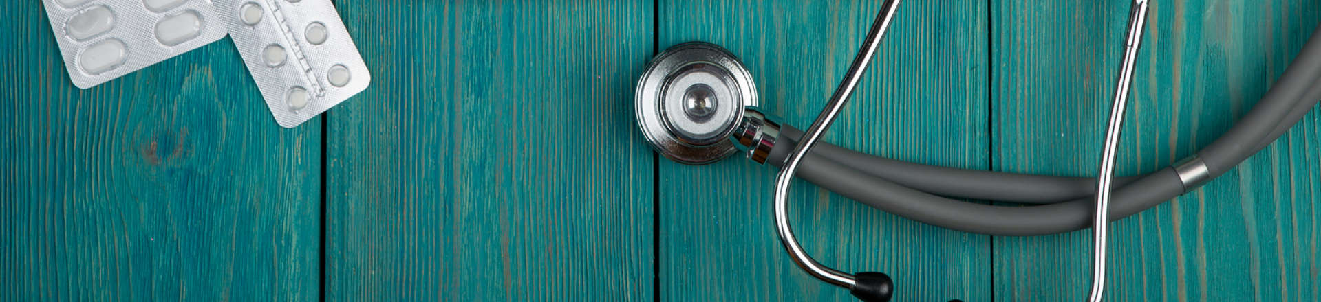 a stethoscope and tablets in blisters