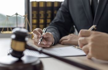 A lawyer consulting a client at the legal office.